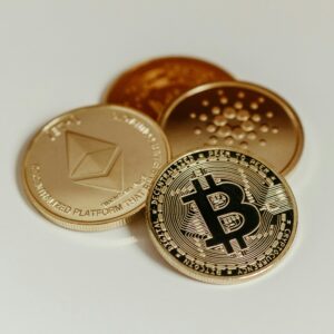 Cryptocurrency coins representing Bitcoin, Ethereum, and Cardano on a white background.